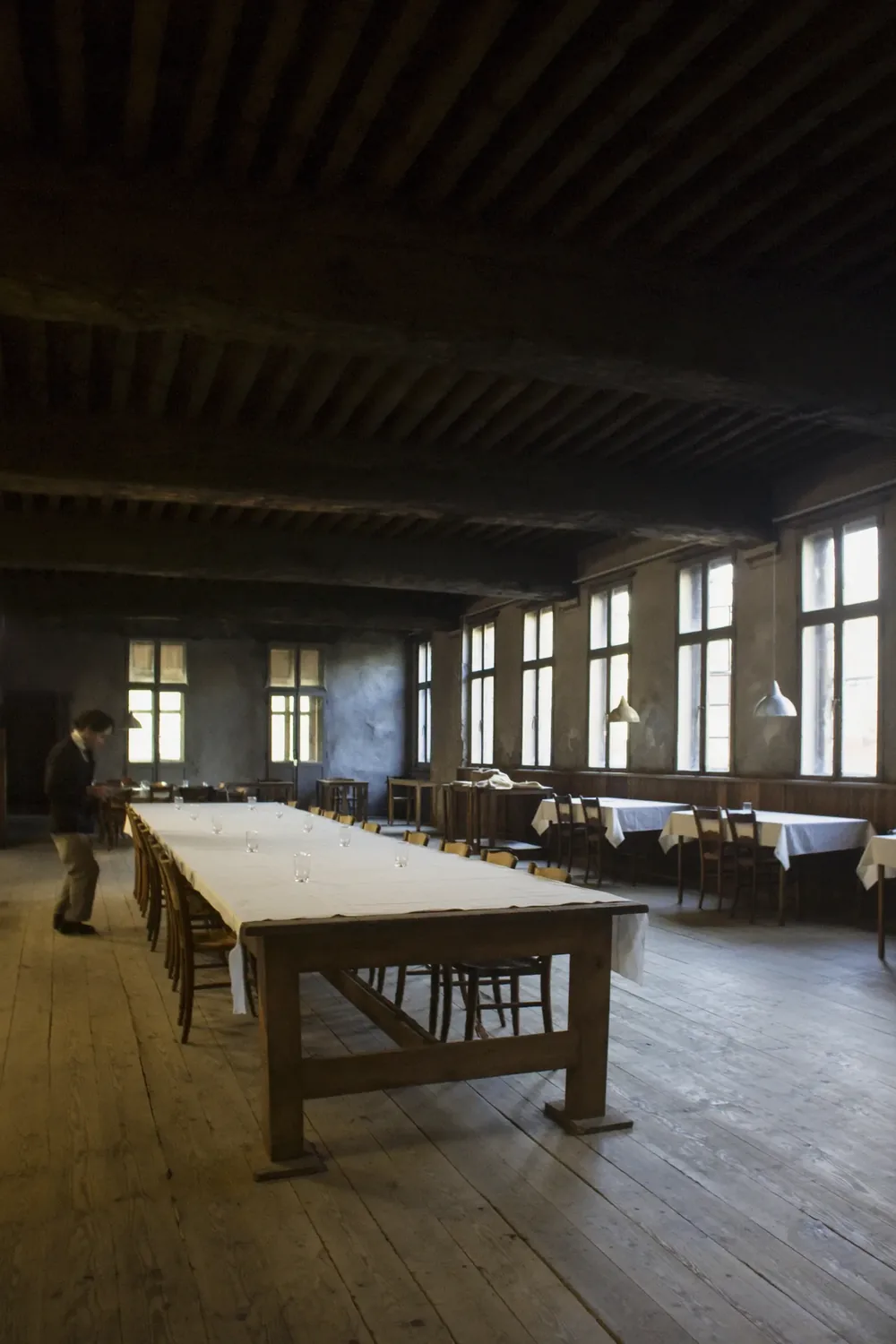 The dining room laid as one long table for a private hire.